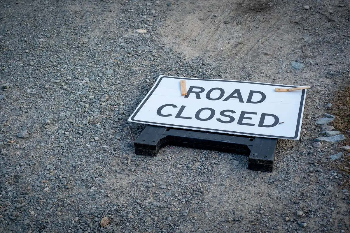 Straße mit Absperrung und Warnschild für Evakuierungsmaßnahmen