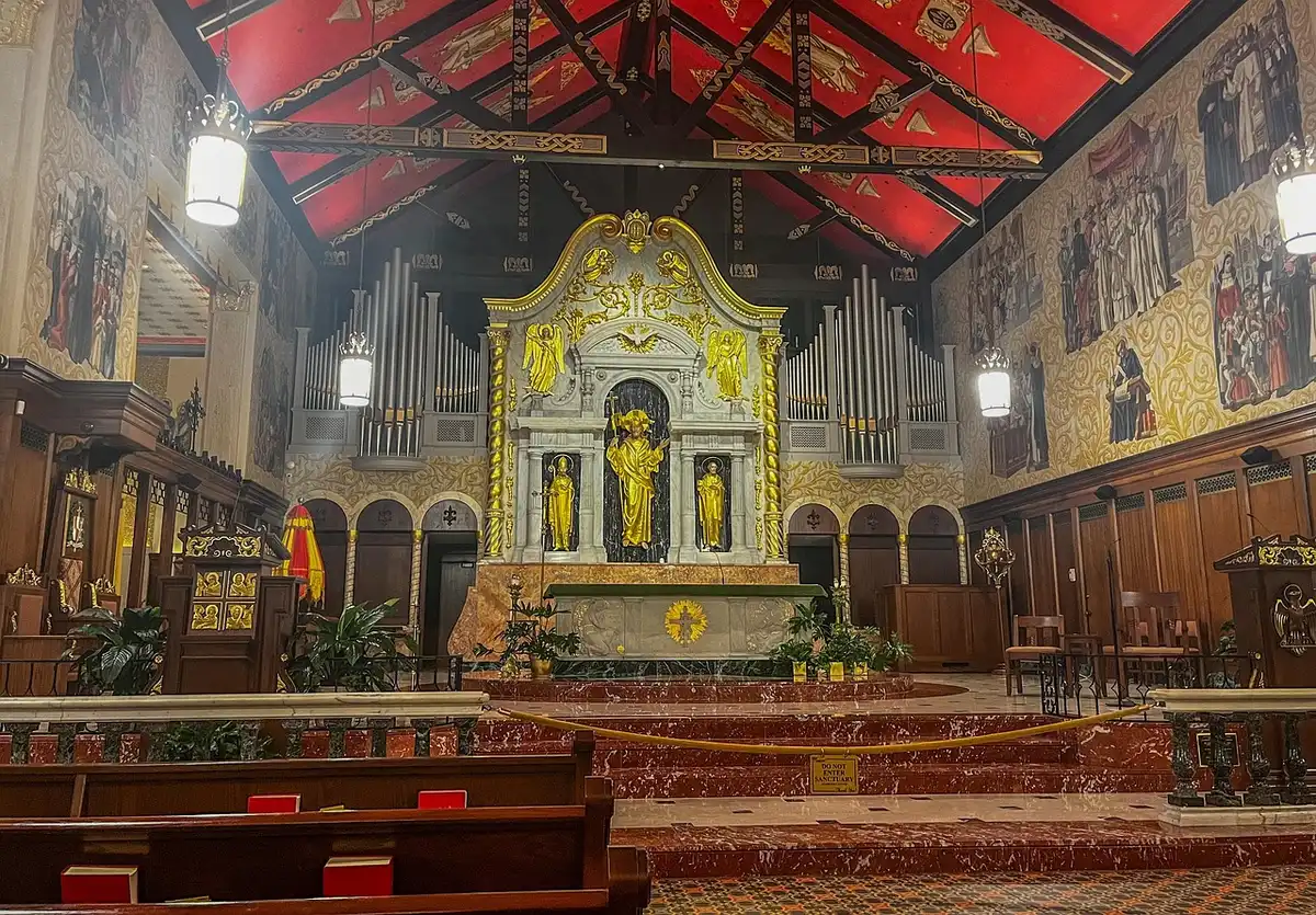 Mehrere Kunstwerke neben Kirchenbänken bereit zur Versteigerung